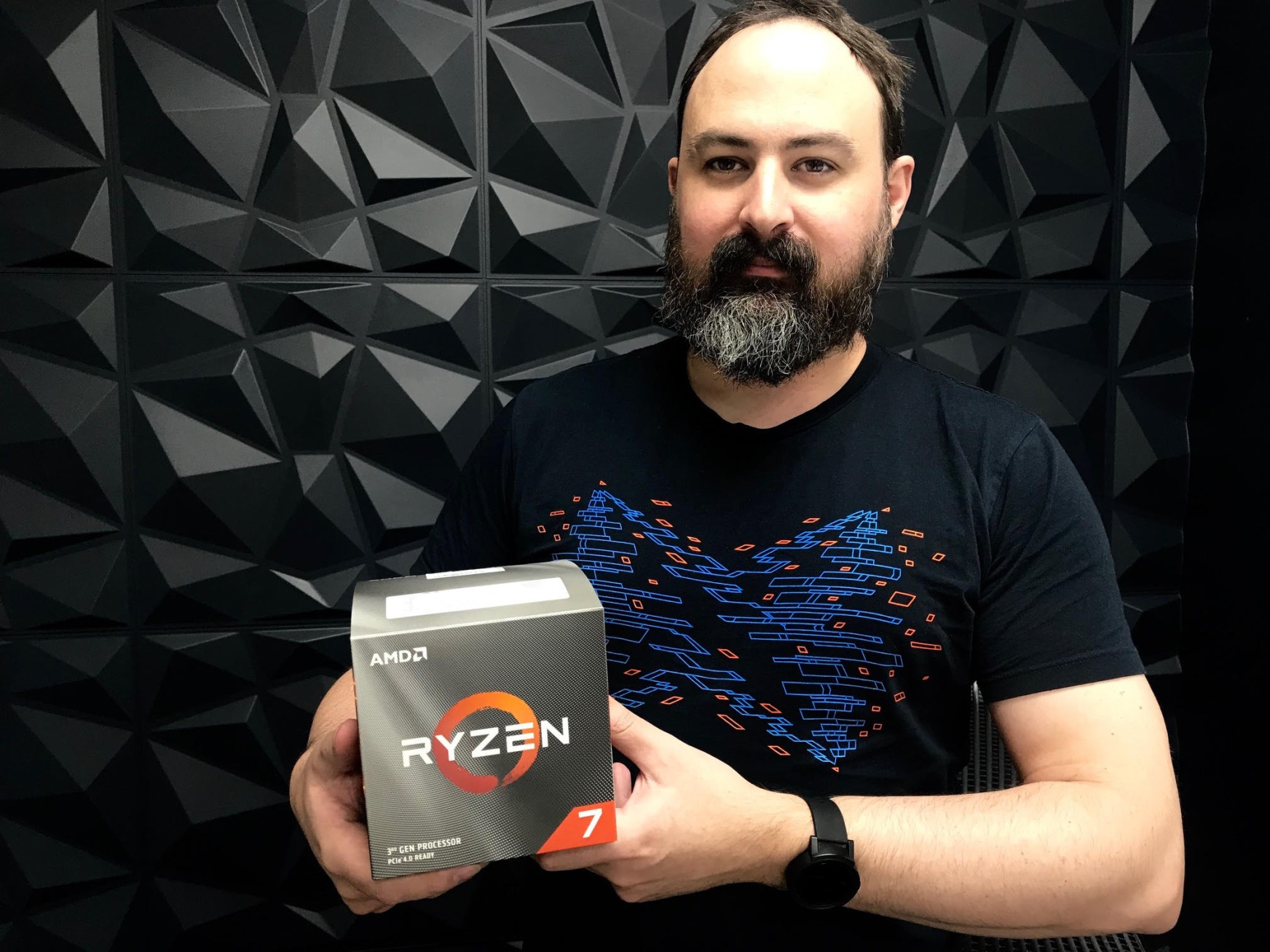 James from SiteHost holding a Ryzen box.