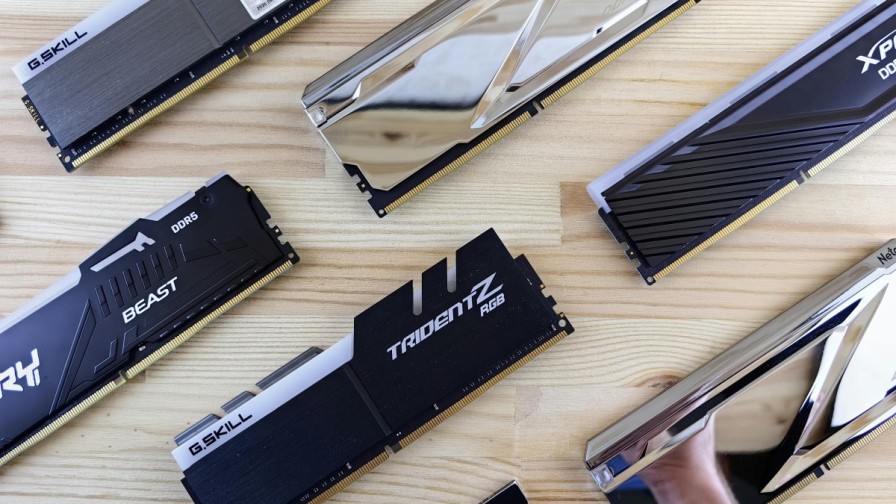 DDR5 RAM sticks laid out evenly on a polished wood table.