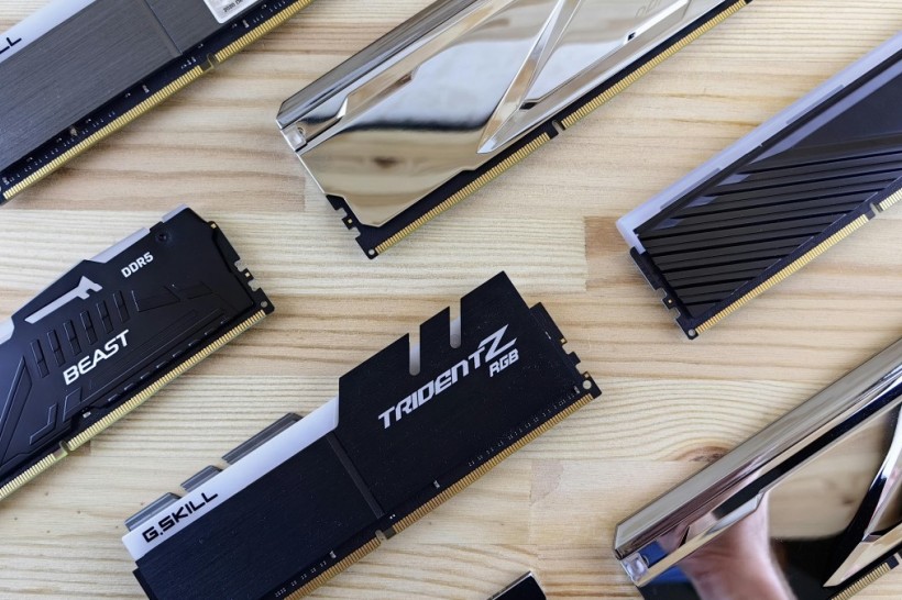 DDR5 RAM sticks laid out evenly on a polished wood table.