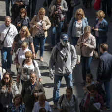 A robot tries to hide among a crowd of humans.