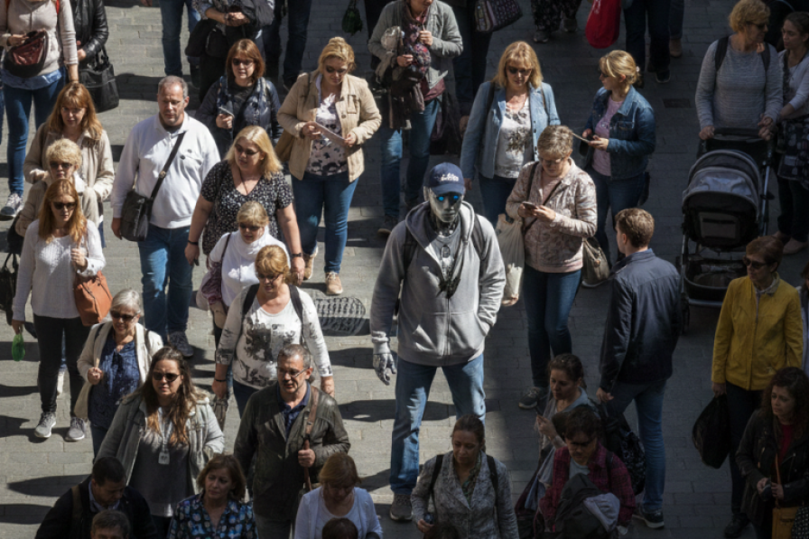 A robot tries to hide among a crowd of humans.