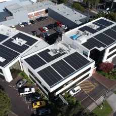 The SiteHost building, seen from air, with over 300 solar panels on the roof.