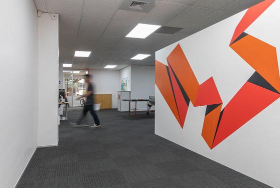 SiteHost's office space with a bold design on the wall.